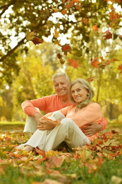 Elderly couple in the orange jacket on a walk