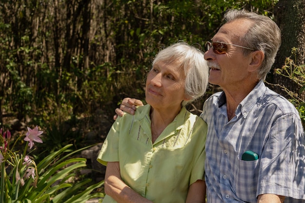 Elderly couple sitting hugging and enjoying time together outdoors. Concept health insurance