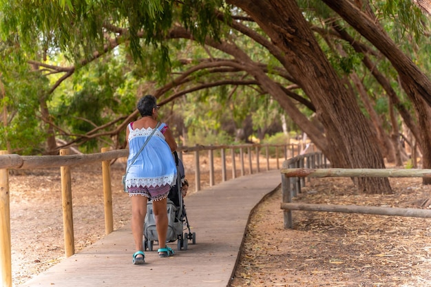 An elderly lady walking on the path of the Lagunas de la Mata Natural Park in Torrevieja Alicante