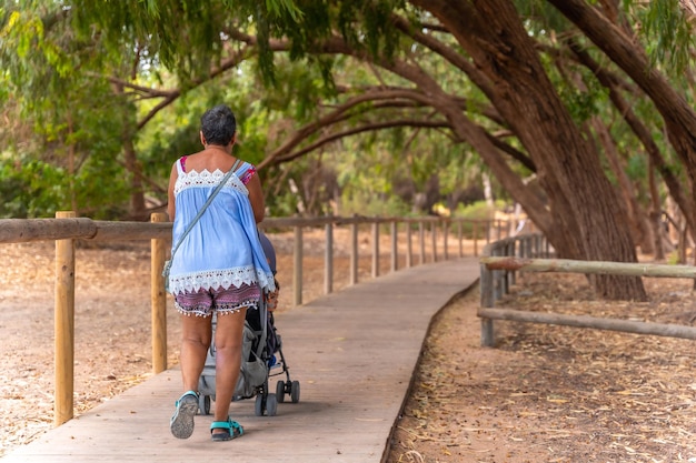 An elderly lady on the wooden footpath in the Lagunas de la Mata Natural Park in Torrevieja Alicante