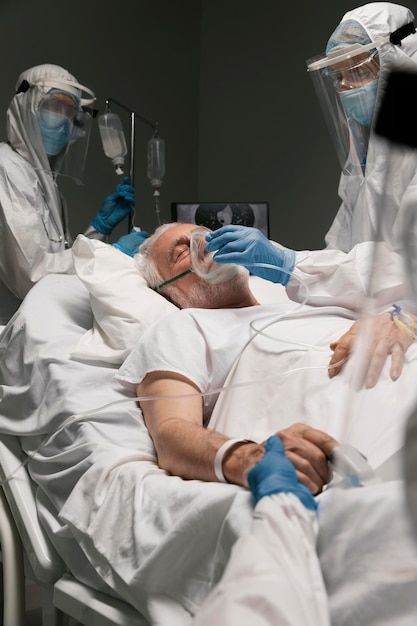 Elderly man breathing with a special equipment