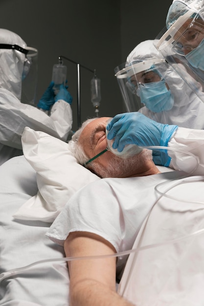 Elderly man breathing with a special equipment