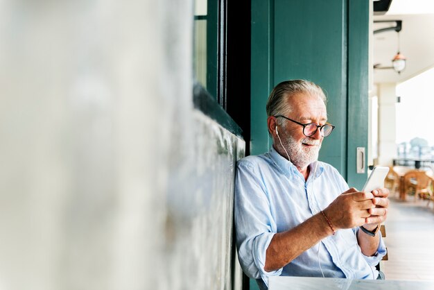 Elderly man is using mobile phone