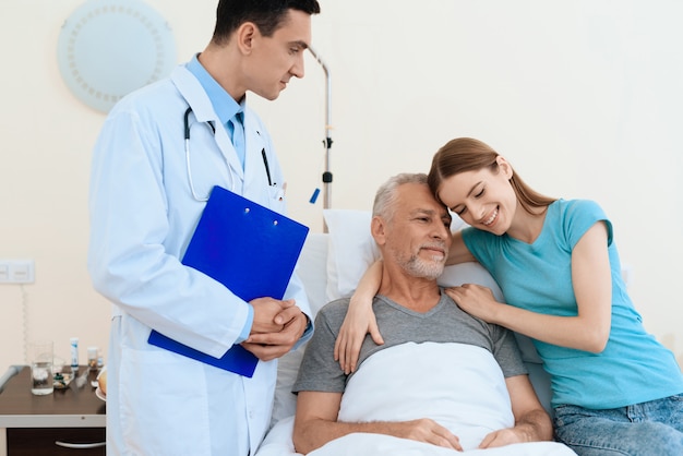 Elderly man lies on a bed. He is undergoing rehabilitation.