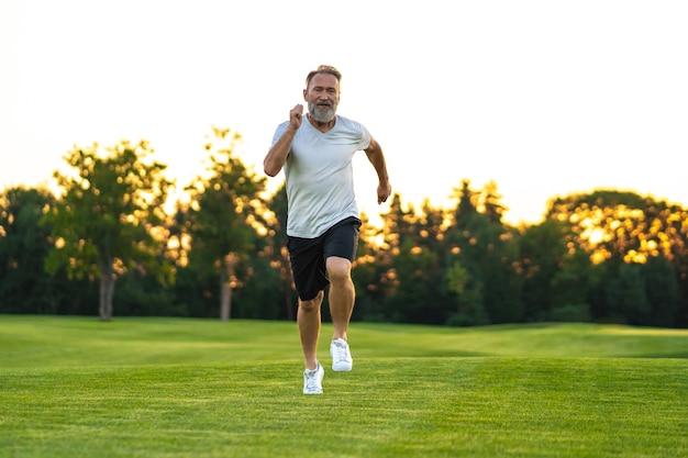 The elderly man running on the lawn