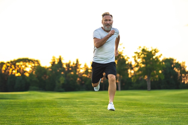 The elderly man running on the lawn