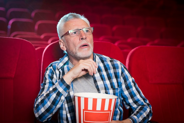 Elderly man watching movie in cinema