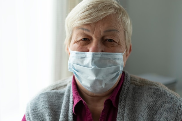 Elderly old woman in a mask.