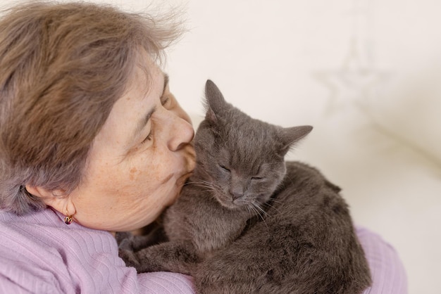 Elderly people take care of cats and enjoy them at home