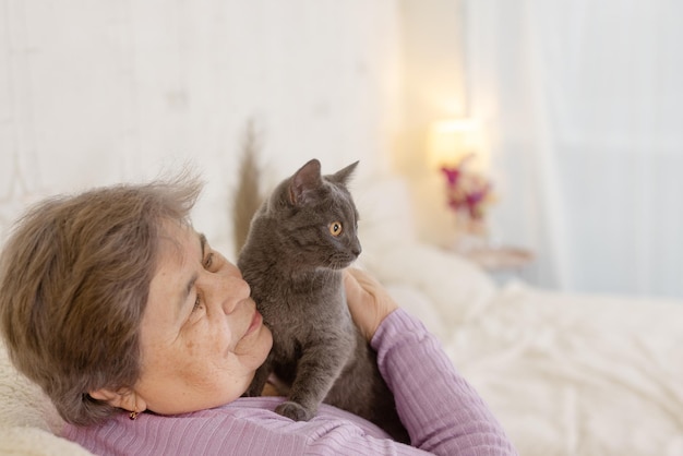 Elderly people take care of cats and enjoy them at home