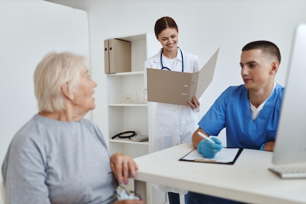 An elderly woman communicates with her sister and a doctor health examination help High quality photo