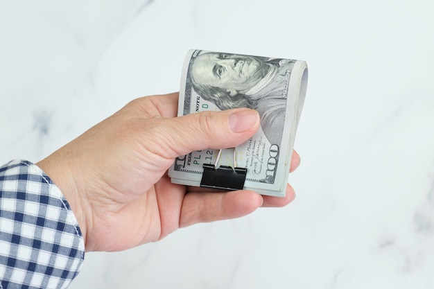 Elderly woman holding Stack of one hundred dollar bills