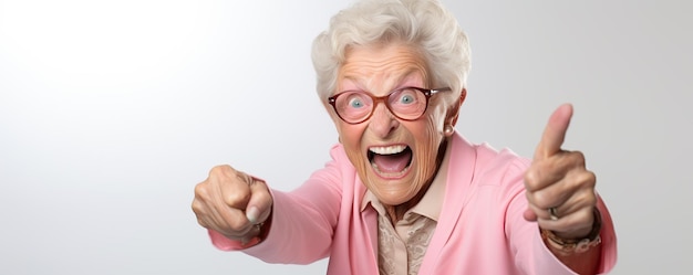 Elderly woman joyfully celebrating with thumbs up gesture in bright setting during cheerful moment