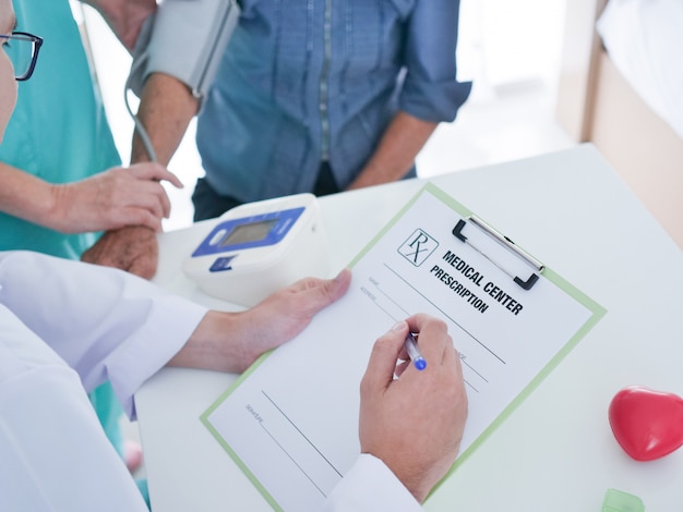 Elderly woman meeting doctor in hospital.