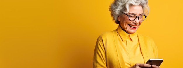 An elderly woman smiling and laughing with her phone against a colored background