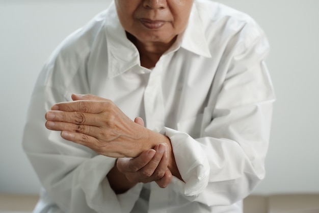 Elderly woman suffering from pain From Rheumatoid Arthritis