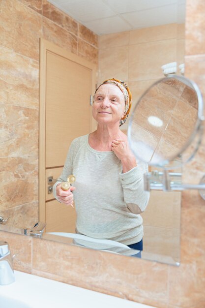 Elderly woman taking care of her face