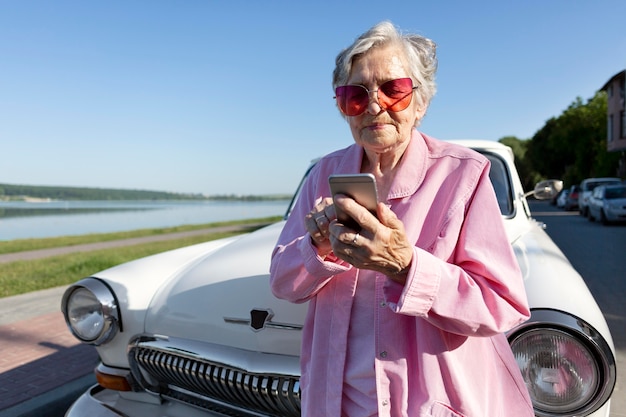 Elderly woman traveling by her car