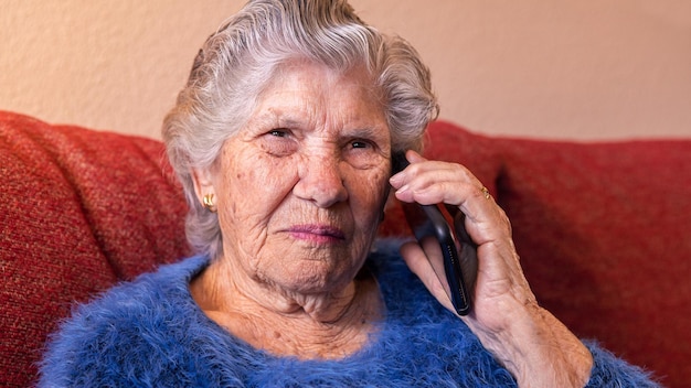 Elderly woman using a smartphone to talking Grandmother speaking mobile phone