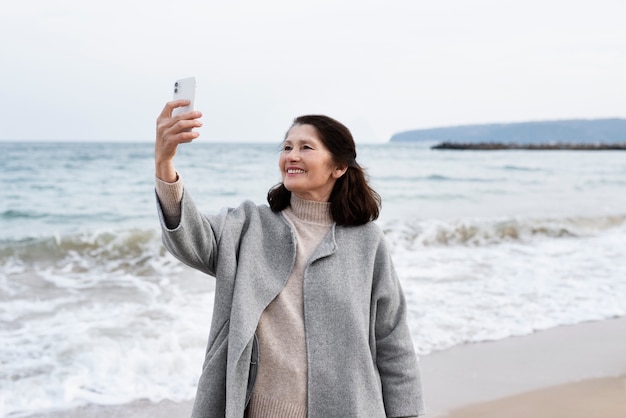 Elderly woman walking by seaside