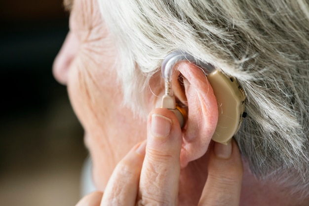 Elderly woman wearing a hearing aid