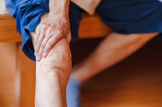 Elderly women have knee pain due to osteoarthritis Concept of health problems in the elderly