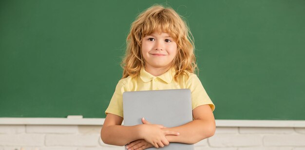 Elearning child studying with computer cheerful teen boy in classroom back to school