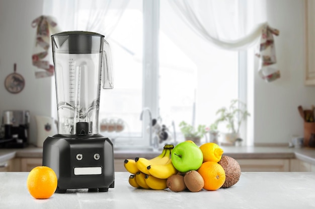 The electric blender for make fruit juice or smoothie on wooden kitchen table. The concept of a healthy diet.