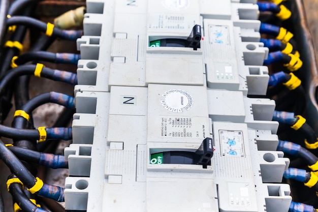 Electric cables connected to a distribution block with switches closeup