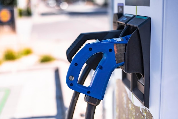 Electric car charging on parking lot with electric car charging station on city street