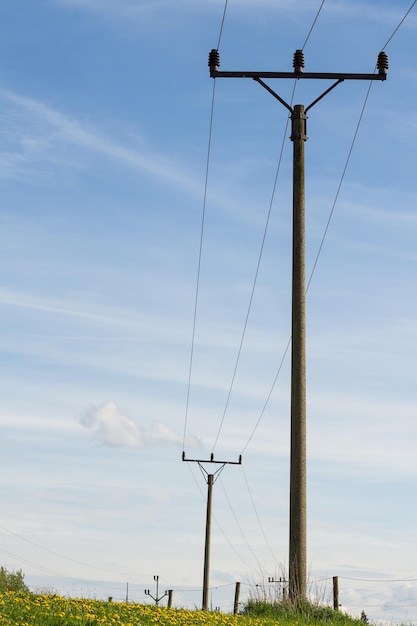 Electric column and wires of high voltage on blue sky background