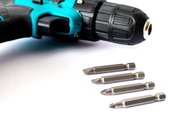 Electric cordless screwdriver and screwdriver bits on a white background