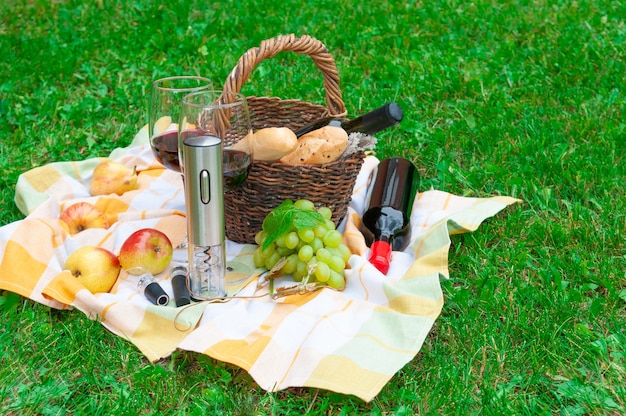 An electric corkscrew stands on a linen towel.