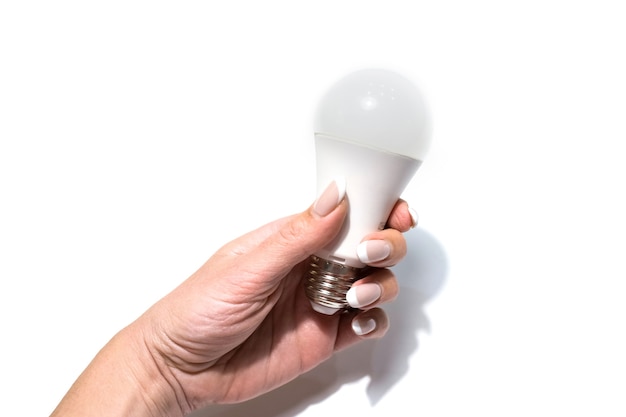 Electric diode light bulb in hand, isolated on white studio background. High quality photo