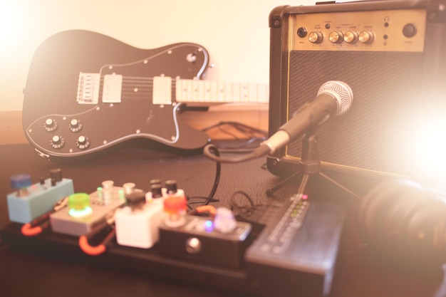 Electric guitar with amplifier guitar on the stage of a concert with warm flare lighting