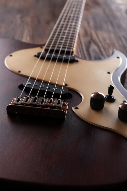 Electric guitar on wooden table close up