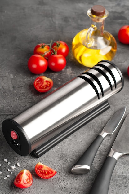 Electric knife sharpener Cylindrical shape made of metal and plastic A gadget for the kitchen