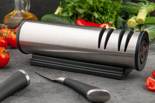 Electric knife sharpener Cylindrical shape made of metal and plastic A gadget for the kitchen