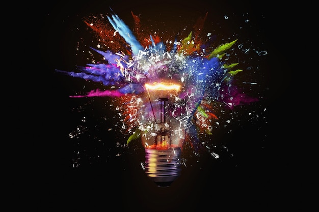 Photo electric light bulb exploding with paint and glass a creative idea business and technology think different concept new thinking and brainstorming