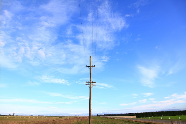 Electric power post with sunny sky