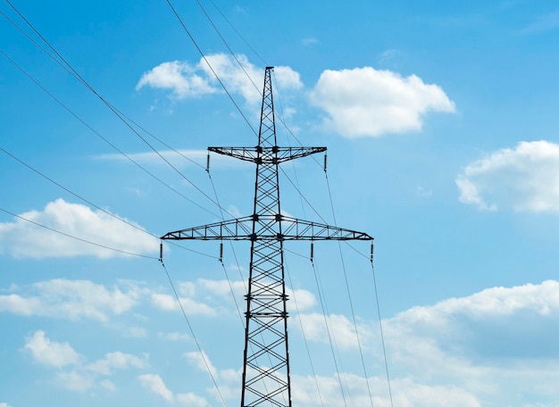 Electric power transmission line at blue sky background