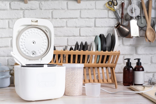 Electric rice cooker on wooden countertop in the kitchen