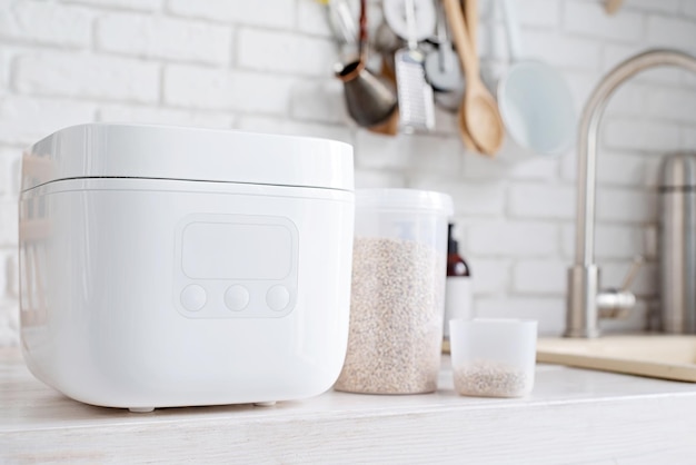 Electric rice cooker on wooden countertop in the kitchen