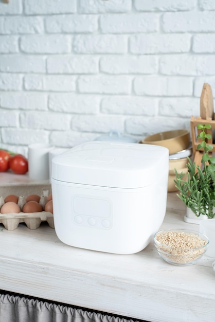 Electric rice cooker on wooden countertop in the kitchen