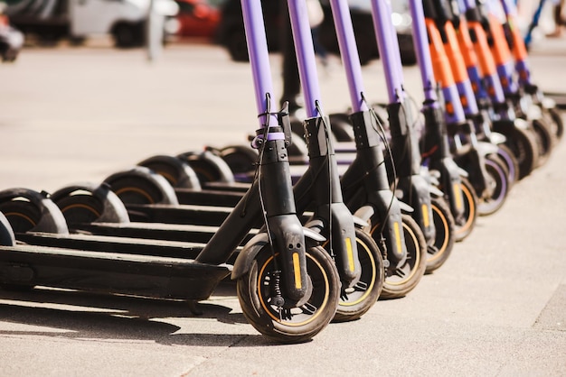 Electric scooters are parked in the city center Modern public mobile transport