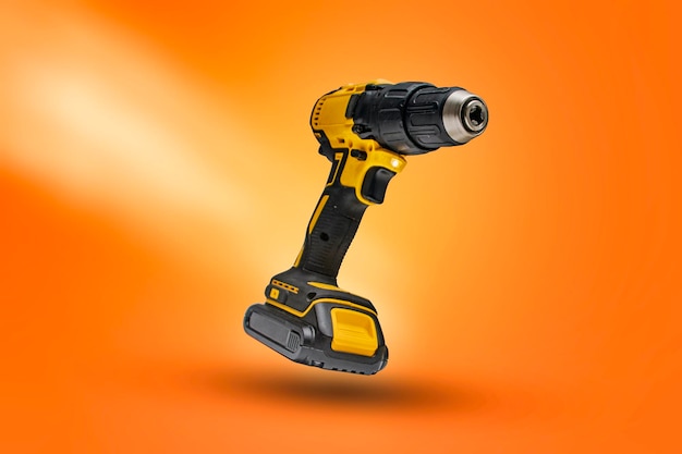 Electric screwdriver on a battery on a orange background