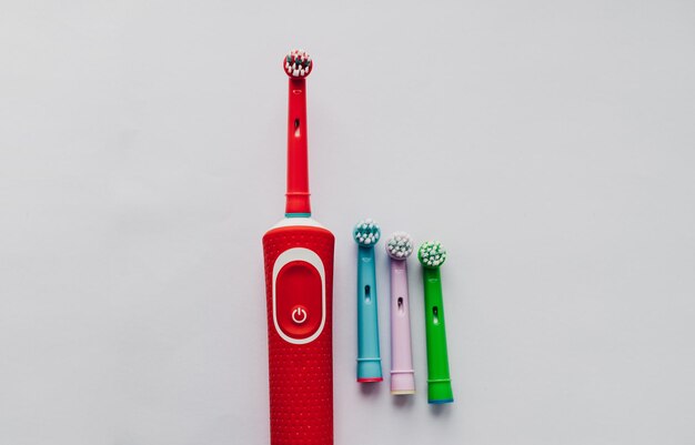 Electric toothbrush with colored nozzles on a colored background