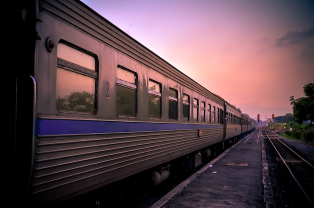 Electric train on railroad with sunset twilight