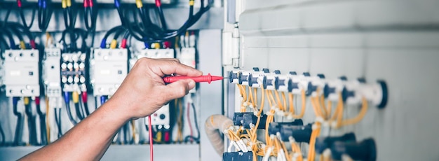 The electrical engineer checks the operation of the electrical control cabinet. maintenance concept