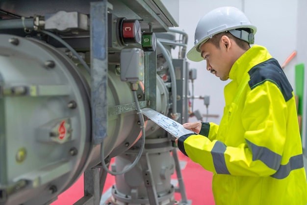 Electrical engineer man checking voltage at the Power Distribution Cabinet in the control roompreventive maintenance YearlyThailand Electrician working at company